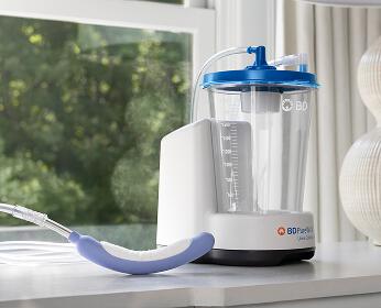 PureWick Urine Collection System with PureWick Flex Female External Catheter on bedroom nightstand