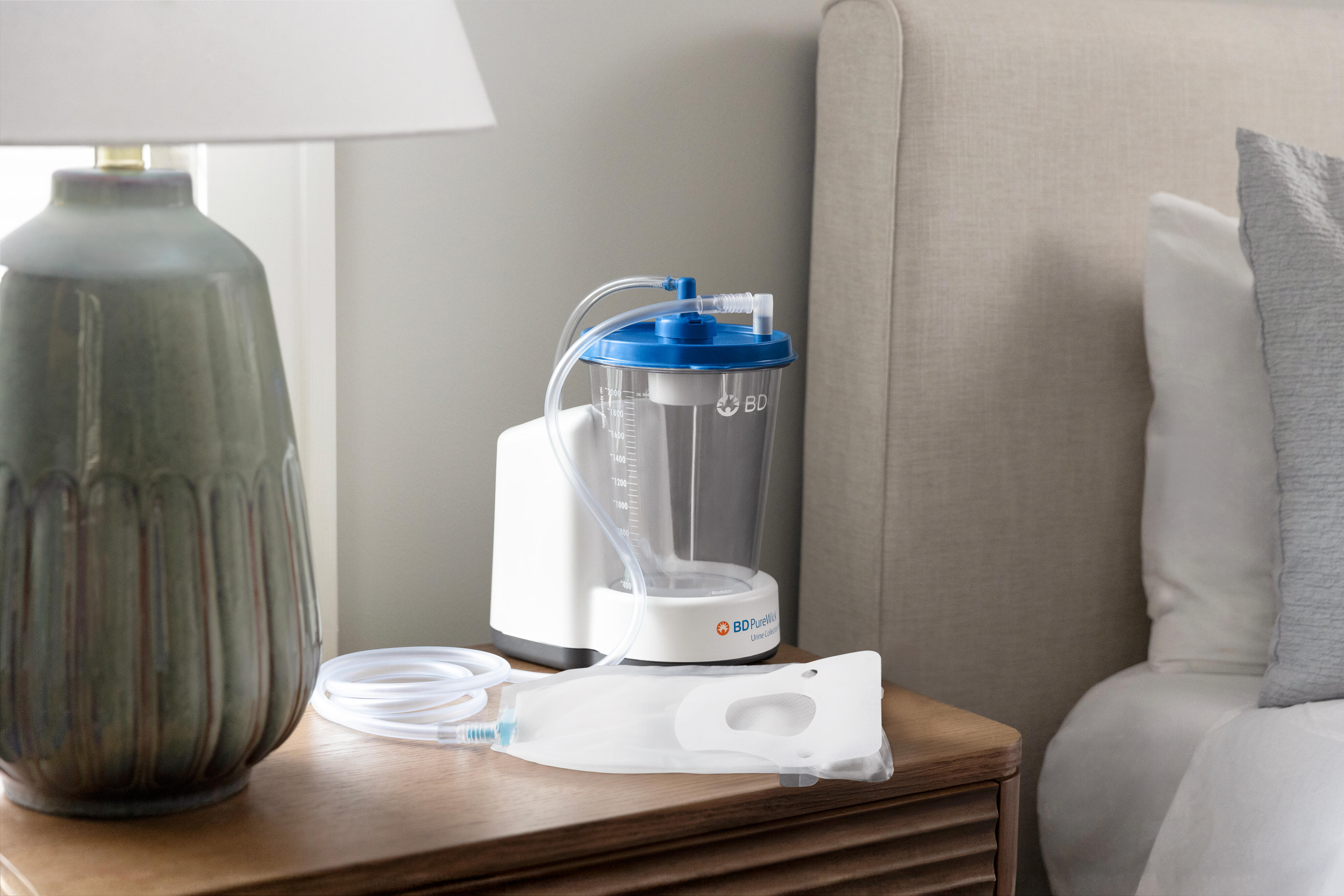 PureWick™ Urine Collection System with attached PureWick™ Male External Catheter on nightstand