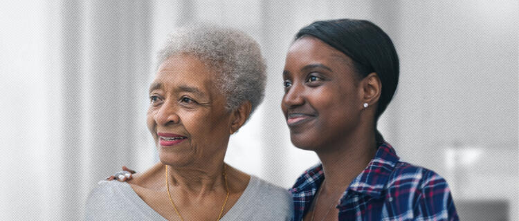 Daughter with arm around her senior citizen mother’s shoulder, both looking away and smiling