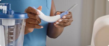 Nurse holding purple PureWick Flex Female External Catheter in a curved position