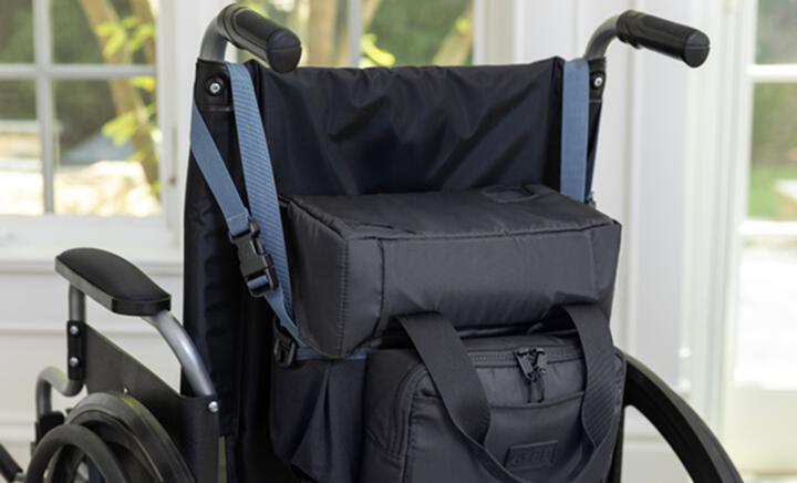 PureWick&trade; Portable Collection System in Carry Bag attached to wheelchair hand grips