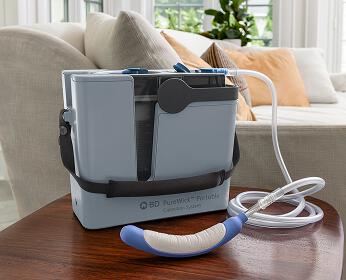 PureWick Portable Collection System with PureWick Flex Female External Catheter on side table in living room