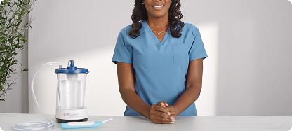 Nurse holding purple PureWick Flex Female External Catheter in a curved position